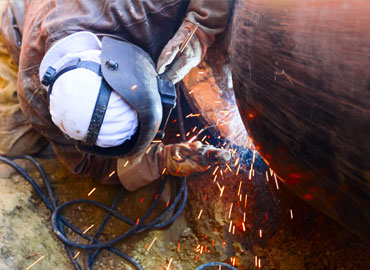 Employee works on pipe sections